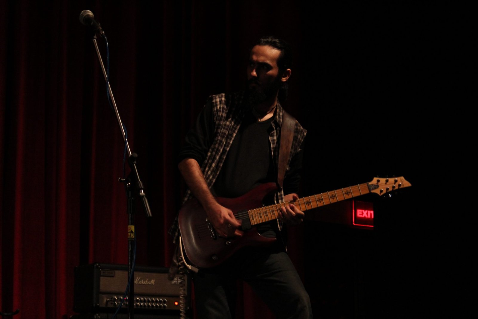 AndishiA on a dimly lit stage